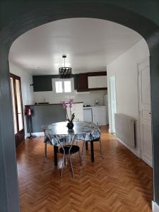 a dining room with a table and a kitchen at gite le sarlat d'oie in Sarlat-la-Canéda +2 photos