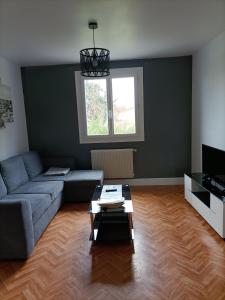 a living room with a couch and a table at gite le sarlat d'oie in Sarlat-la-Canéda