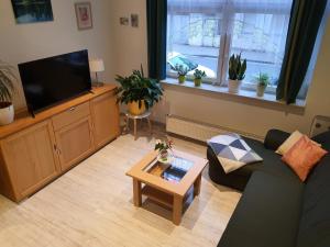 a living room with a couch and a flat screen tv at Ferienwohnung Döring in Erfurt