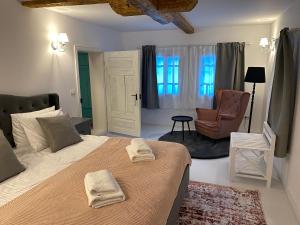 a bedroom with a large bed with towels on it at Hygge Loft Bucovina in Vama