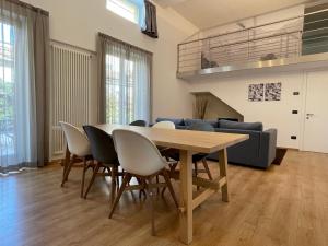 a dining room with a table and chairs at Lovely Loft & Flat in Menaggio