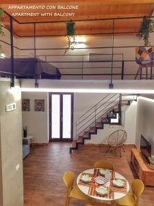 a living room with a table and a staircase at Il Giardino Sulla Valle in Ragusa +19 photos