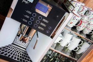 a coffee machine in a coffee shop with cups at Weingut Zirngast in Leutschach