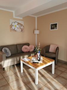 a living room with a couch and a coffee table at Zum Kranichblick FeWo 1&2 in Niepars +7 photos