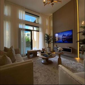 a living room with a couch and a tv at Madinat Jumeirah Living - Lamtara 2 in Dubai