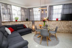 a living room with a couch and a table at Glicinia in Šibenik
