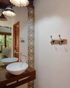 a bathroom with a white sink and a mirror at Solar Pitanga - Taipu de Fora in Barra Grande