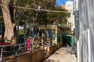 a patio with chairs and tables outside of a building at Glicinia in Šibenik
