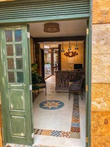 a green door leading into a room with a table at Pousada Sol Da Pipa in Pipa +31 photos