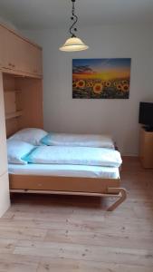 a bed in a bedroom with a painting on the wall at 1-Zimmer-Apartment-2-Hochparterre in Lübeck