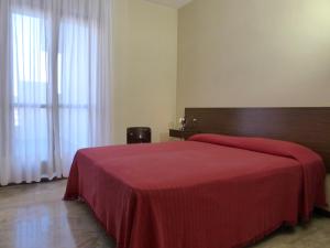 a bedroom with a large bed with a red blanket at Residence Green Park in Ventimiglia +29 photos