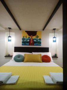 a bedroom with a bed with colorful pillows on it at Pillirina House-boat in Marzamemi