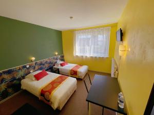 Postel nebo postele na pokoji v ubytování Hotel Le Ronchamp