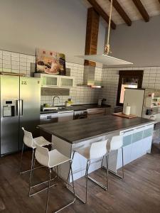 a kitchen with a black counter and white appliances at EL LLANO in Candeleda
