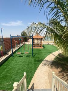 a playground with a gazebo on the beach at Hotel & Resort Golden Marina Yanbu in Yanbu