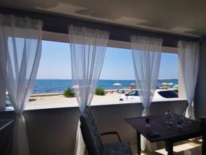 a dining room with a view of the ocean at Apartment Vir in Vir
