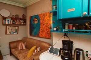 a kitchen with a couch and a painting on the wall at hostel vague in Antalya