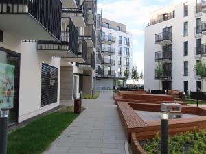 a courtyard with benches and apartment buildings at EL Apartments - Atlas in Poznań