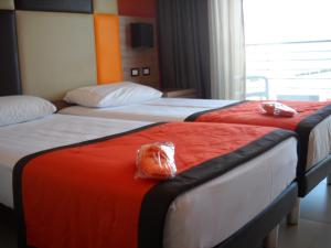 Postel nebo postele na pokoji v ubytování Hotel Tiber Rooftop & Wellness