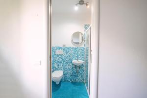 a bathroom with two sinks and a mirror at Safestay Pisa Centrale in Pisa