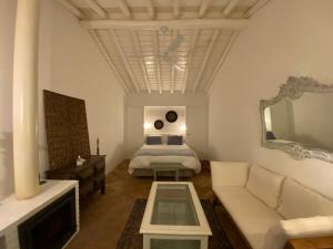 a living room with a bed and a couch at Herdade de Alagães in Mértola