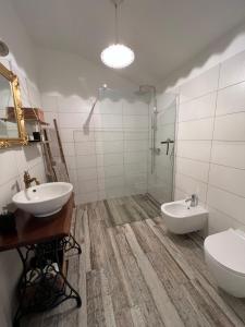 a bathroom with two sinks and a shower and a toilet at Hisa STERNA - WELL HOUSE in Zgornje Škofije