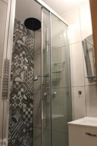 a shower with a glass door in a bathroom at Willa Pod Zielonym Wierchem in Zakopane