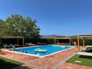 a group of people in a swimming pool at Tenuta Madonnina in Castiglione di Sicilia