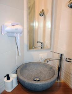 a bathroom with a sink with a hair dryer at La Finestra del Pescò in Lerici +16 photos
