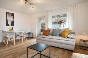 a living room with a couch and a table at Allgäu SPA House in Blaichach