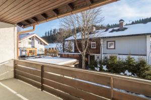 a view from the balcony of a house with snow at Allgäu SPA House in Blaichach