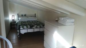 a small bedroom with a bed and a dresser at Harbour Loft in Mytilini