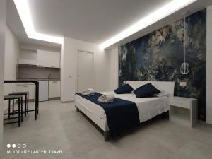 a bedroom with a bed with a painting on the wall at Tropea Travel's House in Tropea