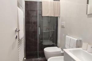 a bathroom with a shower and a toilet and a sink at Villetta Lu Sciardinu in Otranto +26 photos