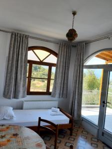Postel nebo postele na pokoji v ubytování Οδυσσέας