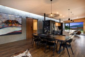 a kitchen and dining room with a table and chairs at Toka Ridge in Hamurana