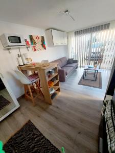 uma sala de estar com uma mesa e um sofá em A cozy private studio near Cattenom, Luxembourg and Metz em Haute-Yutz