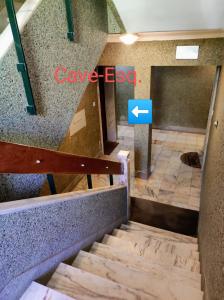 a staircase in a building with a sign that says cave exit at Casas da Eva - Alfragide in Alfragide