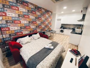 a bedroom with a bed and a wall covered in signs at Estudio Estadio Wanda Metropolitano in Madrid