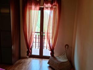 a room with a large window with red curtains at luxury lake in Villetta Barrea