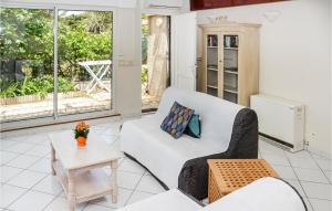 a living room with a white couch and a table at Stunning Home In Le Pradet With 1 Bedrooms And Wifi in Le Pradet