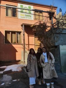 three women standing in front of a building at Bee Lucky Hostel and Tours in Yerevan