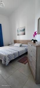 ein Schlafzimmer mit einem Bett und einer Holzkommode in der Unterkunft Holla del Saldo in Ingenio