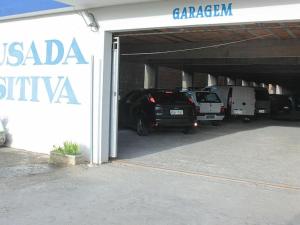 a garage with cars parked inside of it at Hotel Pousada Positiva in Itabuna