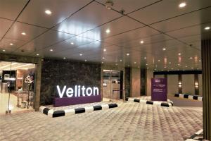 a lobby of a building with a sign on the wall at Veliton Hotel in Al Khobar