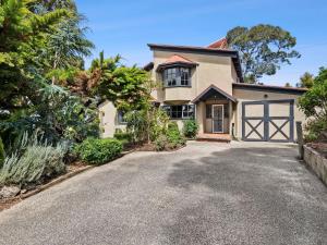 a house with a driveway in front of it at Erskine Beach House in Lorne