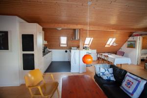 een woonkamer met een bank en een tafel bij Tórshavn - Central - City & Ocean Views - 3BR in Tórshavn