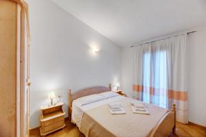 Postel nebo postele na pokoji v ubytování Residenza Pierre et Vacances Badus