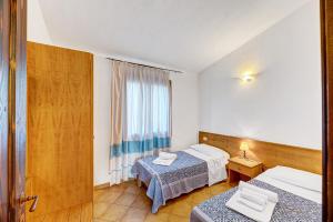 Postel nebo postele na pokoji v ubytování Residenza Pierre et Vacances Badus