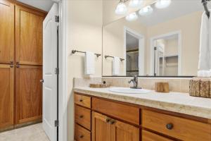 a bathroom with a sink and a mirror at Lazy Bear Lodge Hot Tub Dog Friendly BBQ Grill Forest Views in Guerneville +25 photos